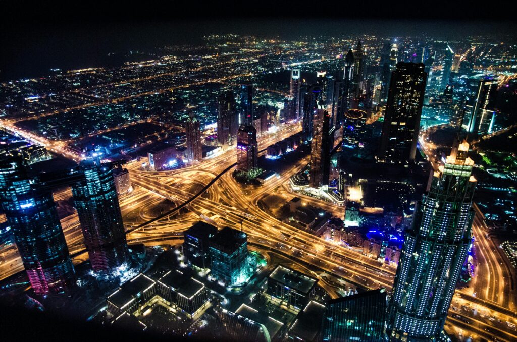 pexels-photo-599982-599982 A stunning aerial view of Dubai's illuminated skyline at night, showcasing its modern architecture and busy roads.